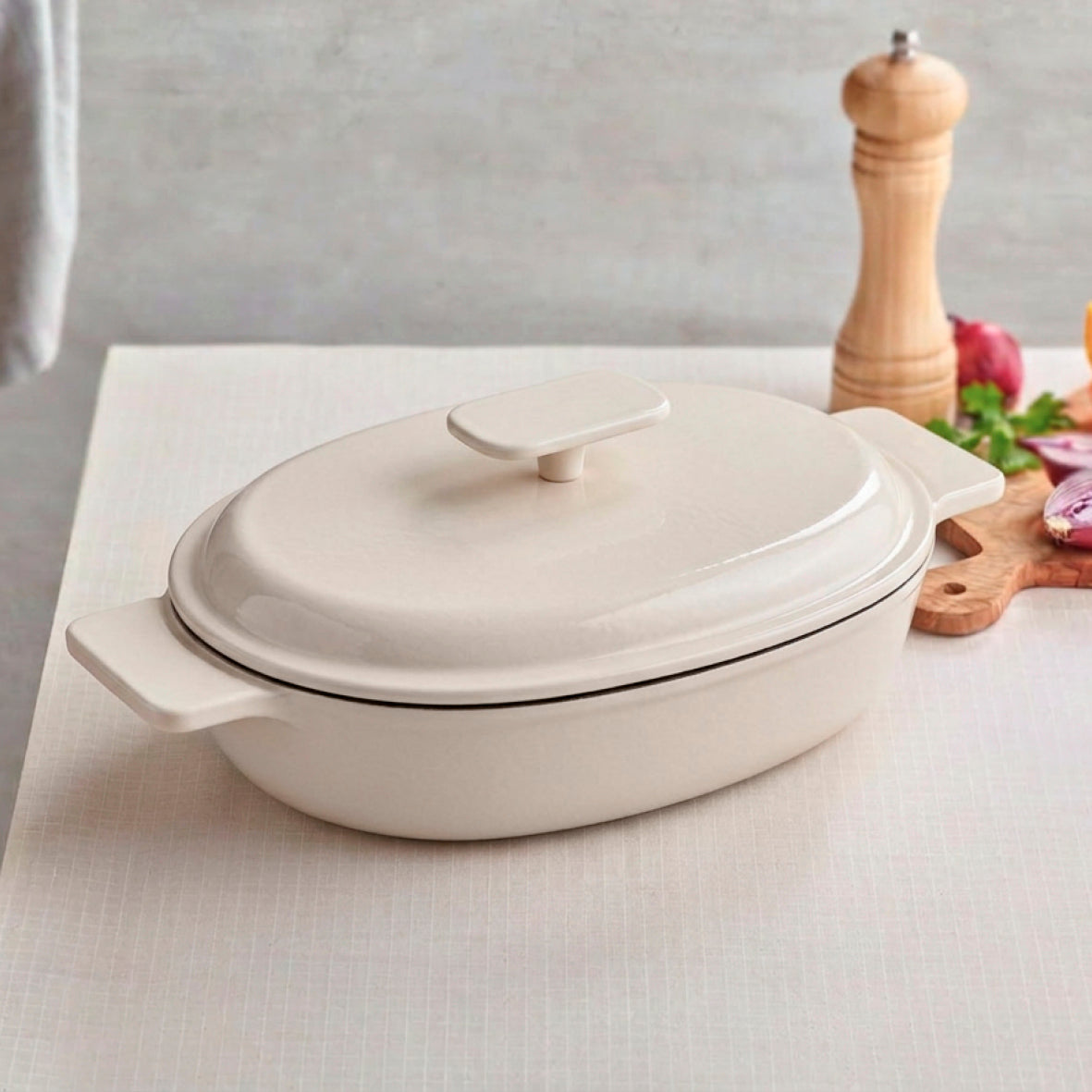 Enamelled cast iron oval casserole with lid - cream